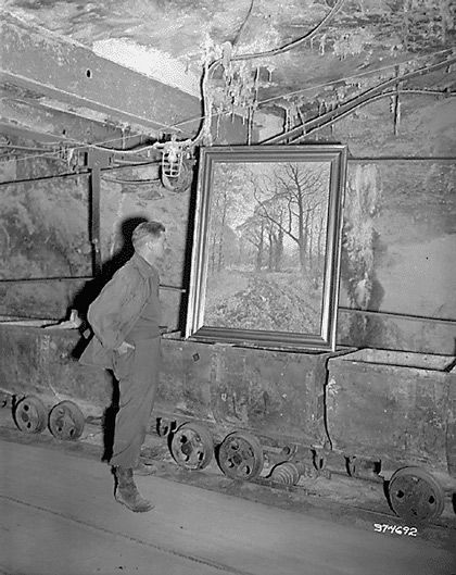 Corporal Donald Ornitz examines painting in underground vault